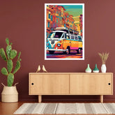 A colorful pop-art poster of a vintage VW bus in a street scene, displayed on a dark brown wall above a light wood console table with decorative items.