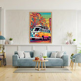 A colorful framed poster of a vintage VW bus in a street scene, displayed on a white wall above a light blue sofa in a modern living room setting.