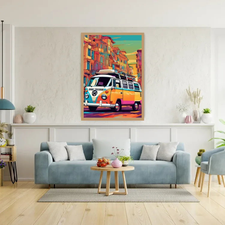 A colorful framed poster of a vintage VW bus in a street scene, displayed on a white wall above a light blue sofa in a modern living room setting.