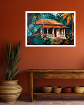A framed art print depicting a traditional house surrounded by lush tropical foliage, displayed on a terracotta wall above a wooden bench with decorative pots.