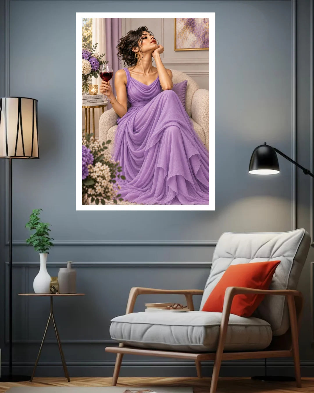 A framed art print depicting a woman in a flowing lavender gown sitting in a chair and holding a glass of red wine, displayed on a dark gray wall above a modern armchair in a styled living room.