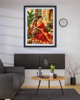 A framed art print depicting a woman in a red sari playing a stringed instrument, hung on a white wall above a modern gray cabinet in a living room setting.