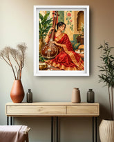 A framed art print featuring a woman in a red sari playing a stringed instrument, displayed on a beige wall above a light wood console table with decorative vases and plants.