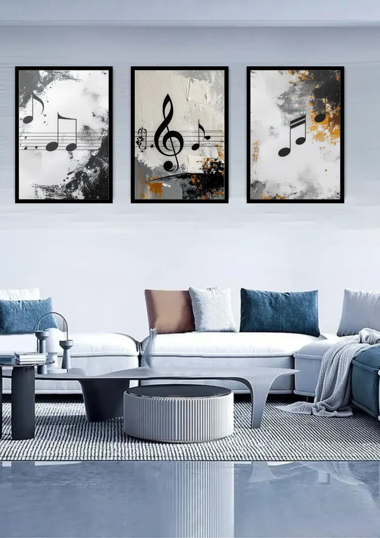 Three framed abstract musical note wall art prints hang above a modern white sofa in a bright, contemporary living room.