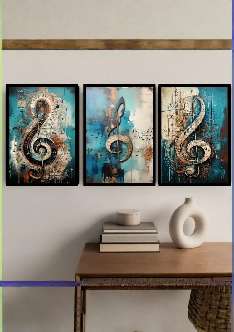 Three framed abstract wall art prints featuring large treble clefs in blue, teal, beige, and black tones, displayed above a wooden console table with books and a white vase.