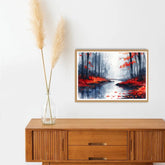 Framed artwork of a forest scene with red leaves on a wooden sideboard.