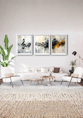 Modern living room with a white sofa, decorative plants, and abstract art on the wall.