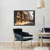 A framed art print depicting an ancient stone temple carved into a cliffside, displayed on a textured white wall in a modern living room setting with a navy blue velvet armchair, a round marble-top table, and a hanging woven pendant lamp.