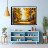 Framed painting of a forest scene above a blue cabinet with decorative items.