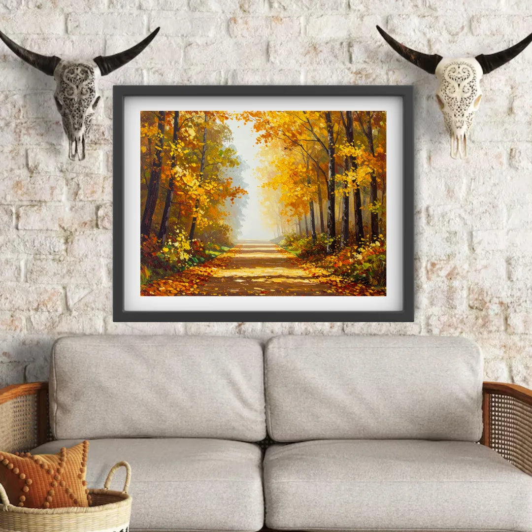 Framed painting of an autumn forest on a wall above a sofa with decorative skulls.