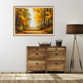 Wooden dresser with a painting of an autumn forest on the wall above it.