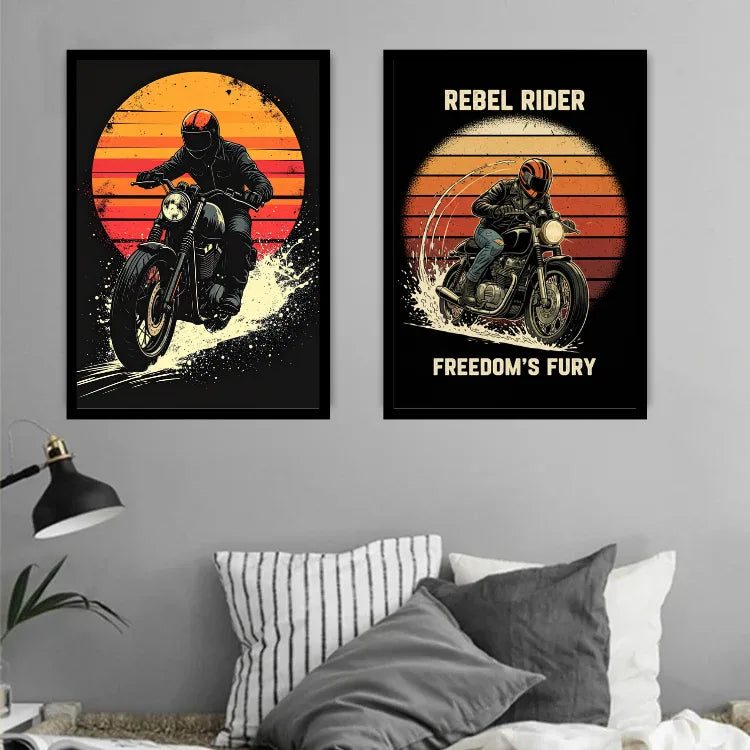 Two framed wall art prints featuring a motorcycle rider against a retro sunset are displayed above a bed in a bedroom setting. The left print shows the rider leaning forward on a black motorcycle, and the right print reads &