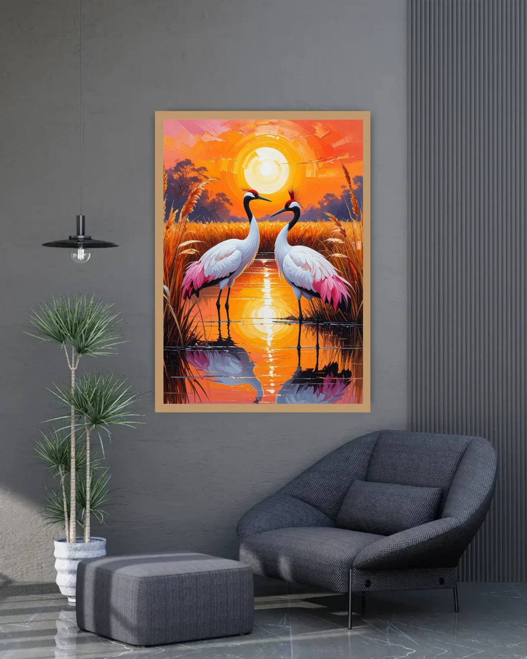 Framed artwork of two cranes in a sunset setting on a gray wall above a modern chair.