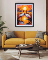 Yellow sofa in a living room with a painting of cranes on the wall.