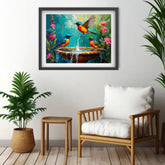 Framed painting of birds by a chair and plant in a room