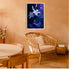 Blue floral abstract wall art framed above a cozy chair in a modern home interior
