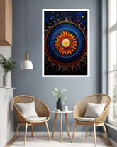 A framed vertical art print featuring a vibrant bohemian mandala sun design, displayed on a gray wall in a modern living room setting with two woven chairs and a small side table.