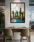 Framed cityscape painting on a white wall above a dining table with chairs.