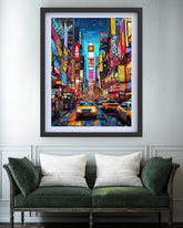 Framed artwork of a vibrant city street scene with neon lights above a green sofa.