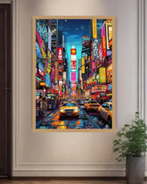 Framed artwork of a vibrant city street scene with neon lights and taxis, on a white wall.