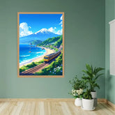 A framed vertical art print depicting a scenic coastal landscape with a train, beach, ocean, and a snow-capped mountain, displayed on a sage green wall above a light wood floor with potted plants nearby.