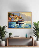 A framed canvas painting of a scenic coastal town with a ferry on the water, displayed on a light gray wall above a wooden console table with plants and decorative items.