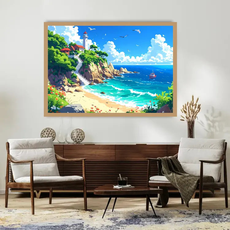 A framed colorful coastal landscape painting hangs on a white wall above a wooden console and two armchairs in a styled living room. The artwork depicts a sunny beach scene with turquoise ocean water, sandy shore, green cliffs, and a lighthouse.