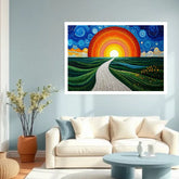 A framed wall art print depicting a stylized sunset over rolling green hills with a winding path, displayed above a cream sofa in a modern living room setting.