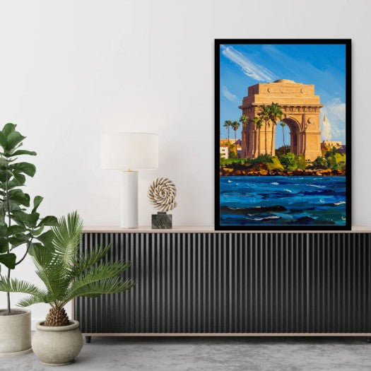 A framed art print depicting the India Gate monument in Kolkata, styled on a black ribbed console table in a modern living room setting.