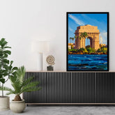 A framed art print depicting the India Gate monument in Kolkata, styled on a black ribbed console table in a modern living room setting.
