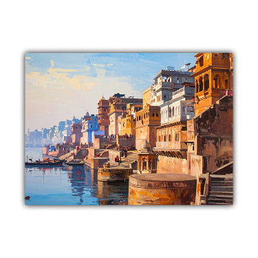 A rectangular canvas print depicting a colorful riverside city scene with warm orange and beige buildings, blue water, and a soft sky, shown against a plain white background.