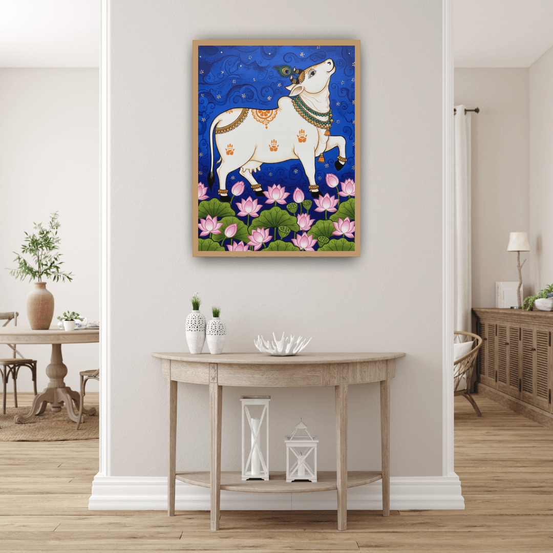 Decorative painting of a cow on a wall in a room with a table and chairs.