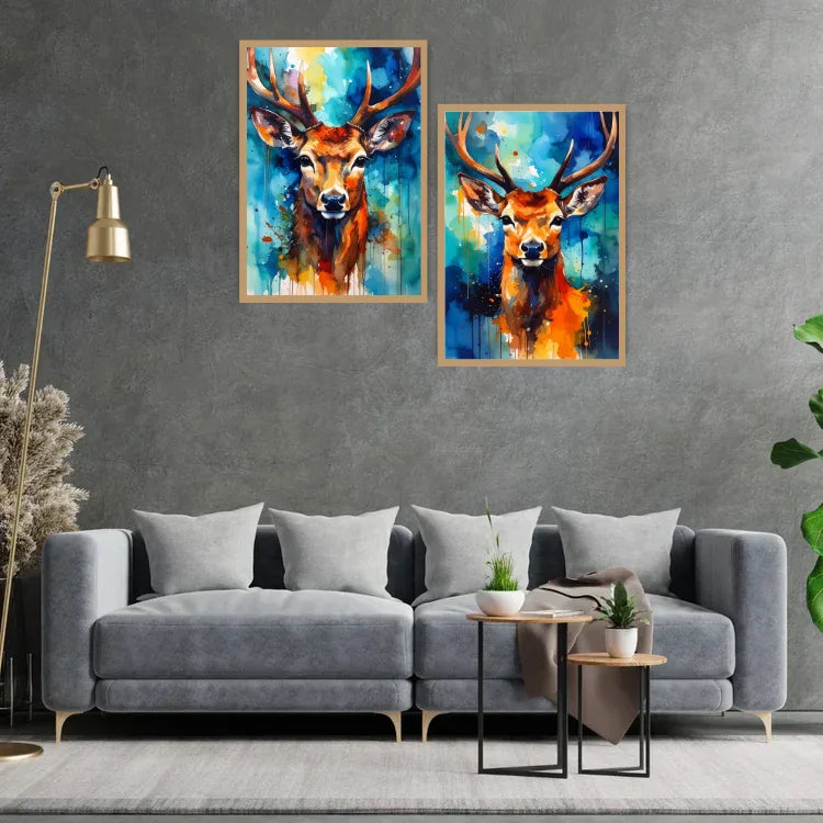 Two colorful deer paintings on a gray wall above a gray sofa.