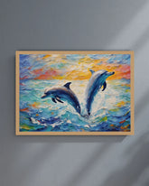 Framed painting of two dolphins leaping in water with a colorful background on a gray wall.