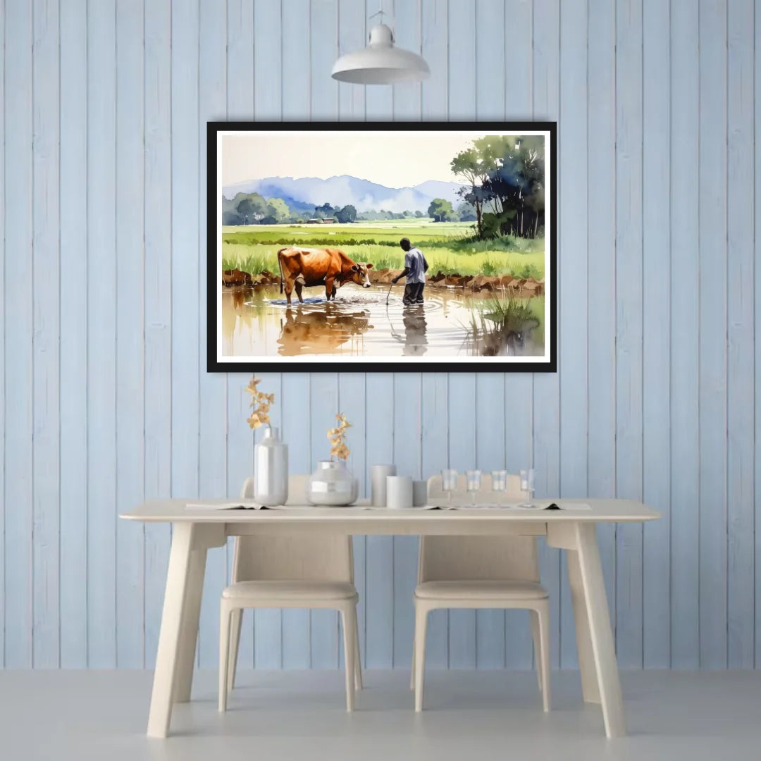 Framed landscape painting of a farmer and cow by a pond on a blue paneled wall above a dining table.