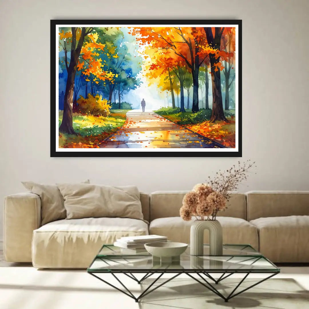 Framed painting of a forest path with autumn colors above a beige sofa in a living room.