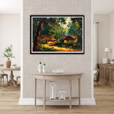 Framed landscape painting on a wall above a table in a room with wooden flooring.