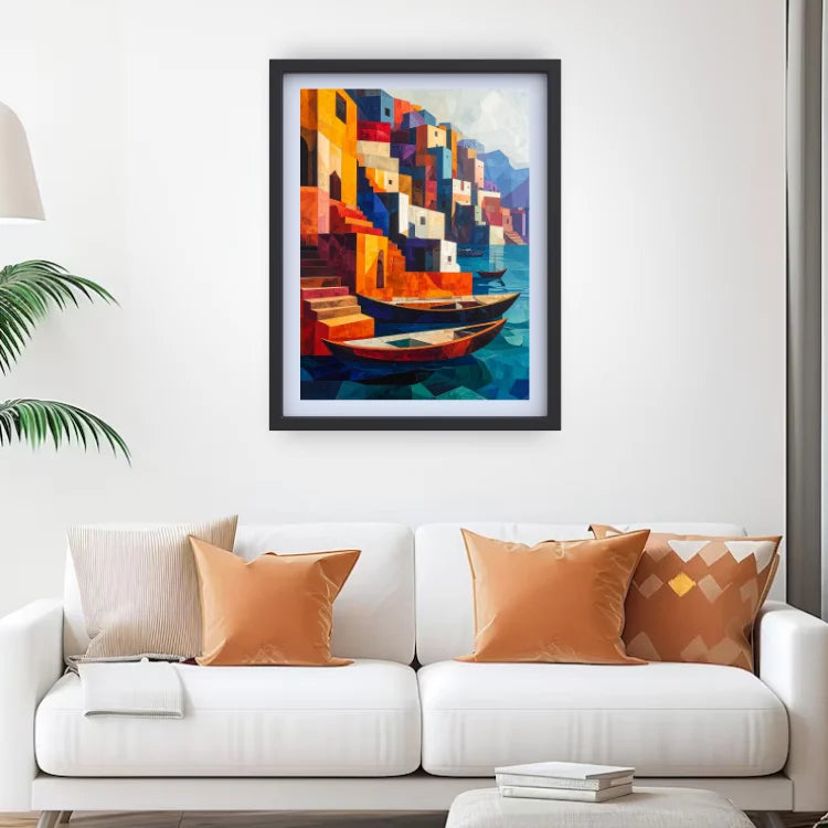 A framed colorful painting of a Mediterranean harbor with boats and stacked buildings, displayed on a white wall above a modern white sofa with decorative pillows.