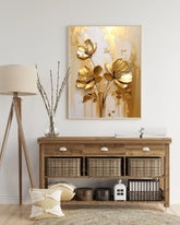 Gold floral wall art canvas displayed above a wooden console table in a modern interior
