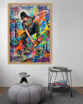 Colorful poster of a skateboarder with text on a wall above a gray ottoman and small table.