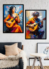 Two framed colorful paintings of guitar players displayed on a white brick wall above a dark gray sofa in a living room setting.