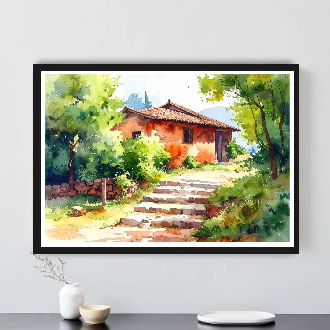 Framed painting of a rustic house with greenery on a white wall.