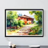 Framed painting of a rustic house with greenery on a white wall.
