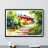 Framed painting of a rustic house with greenery on a white wall.