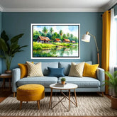 Living room with a blue sofa, yellow ottoman, and a painting of a tropical scene on the wall.