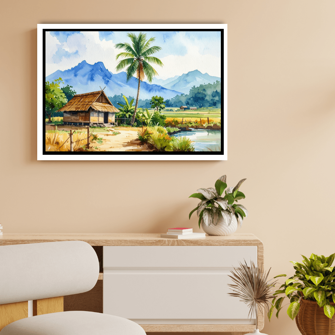 Framed landscape painting of a hut and palm tree on a wall above a desk.