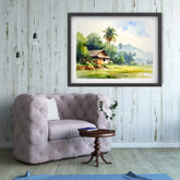 Framed landscape painting above a gray sofa in a room with wooden floor and white walls.