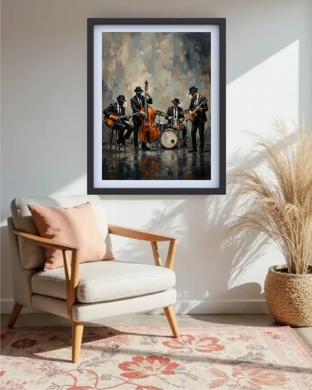 A framed art print depicting a jazz band performing, styled in a modern living room setting above a light beige armchair with a pink pillow and next to a potted pampas grass plant.