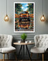 Framed artwork of a Jeep in a forest setting above a table with chairs in a room.