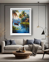 A framed tropical landscape painting featuring palm trees, a small boat on blue water, and a house, displayed on a gray wall above a modern beige sofa in a styled living room.